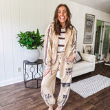 Lightweight, nearly sheet knit sweater with capped sleeves in cream with dark brown stripes and middle front seam detail.