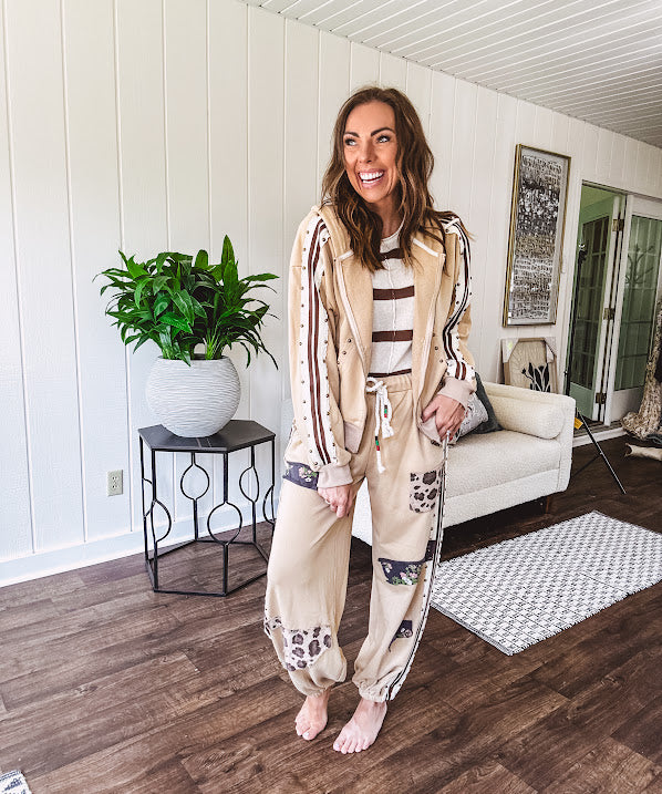 Lightweight, nearly sheet knit sweater with capped sleeves in cream with dark brown stripes and middle front seam detail.
