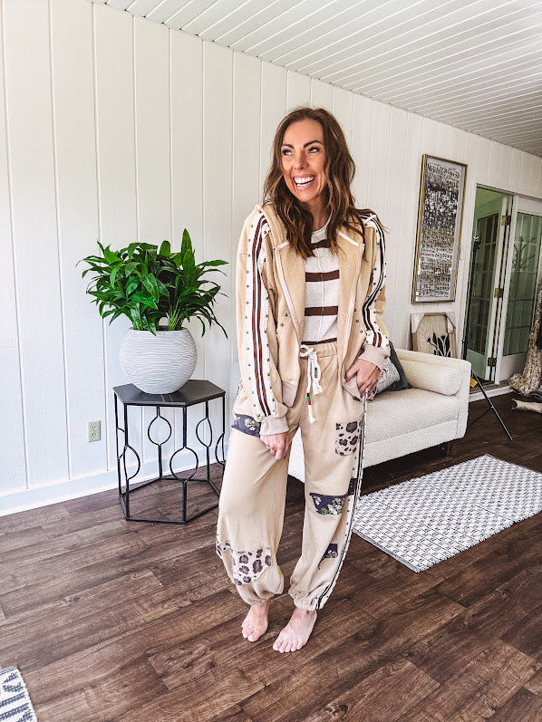 Lightweight, nearly sheet knit sweater with capped sleeves in cream with dark brown stripes and middle front seam detail.