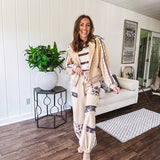 Lightweight, nearly sheet knit sweater with capped sleeves in cream with dark brown stripes and middle front seam detail.
