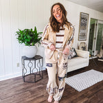 Lightweight, nearly sheet knit sweater with capped sleeves in cream with dark brown stripes and middle front seam detail.