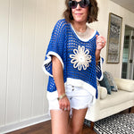Open weave crochet sweater with 3/4 sleeves and large contrasting crochet flower on the front and contrasting trim. Oversized. Available in multiple colors.