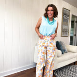 Cotton button and zipper closure bright floral pants with seams down the front of both legs and front and back pockets.