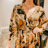 Brown, black, rust and bold geode print maxi dress with V neck, elastic waist and 3/4 sleeves.