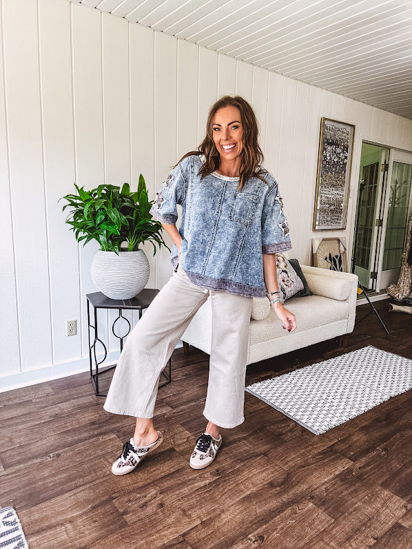 Crafted from a soft cotton-blend in a medium wash, this short-sleeved shirt features eye-catching floral and ribbed patchwork details that make it impossible to ignore. The relaxed fit, seam detailing, and front pocket keep things effortlessly comfortable, while the textured cuffs and hem add that signature boho edge.