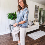 Crafted from a soft cotton-blend in a medium wash, this short-sleeved shirt features eye-catching floral and ribbed patchwork details that make it impossible to ignore. The relaxed fit, seam detailing, and front pocket keep things effortlessly comfortable, while the textured cuffs and hem add that signature boho edge.