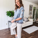 Crafted from a soft cotton-blend in a medium wash, this short-sleeved shirt features eye-catching floral and ribbed patchwork details that make it impossible to ignore. The relaxed fit, seam detailing, and front pocket keep things effortlessly comfortable, while the textured cuffs and hem add that signature boho edge.