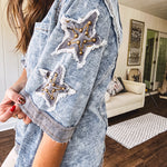 Crafted from a soft cotton-blend in a medium wash, this short-sleeved shirt features eye-catching floral and ribbed patchwork details that make it impossible to ignore. The relaxed fit, seam detailing, and front pocket keep things effortlessly comfortable, while the textured cuffs and hem add that signature boho edge.