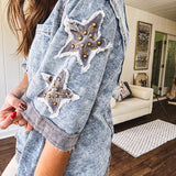 Crafted from a soft cotton-blend in a medium wash, this short-sleeved shirt features eye-catching floral and ribbed patchwork details that make it impossible to ignore. The relaxed fit, seam detailing, and front pocket keep things effortlessly comfortable, while the textured cuffs and hem add that signature boho edge.