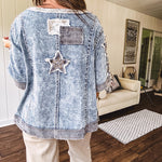 Crafted from a soft cotton-blend in a medium wash, this short-sleeved shirt features eye-catching floral and ribbed patchwork details that make it impossible to ignore. The relaxed fit, seam detailing, and front pocket keep things effortlessly comfortable, while the textured cuffs and hem add that signature boho edge.