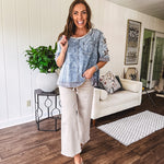 Crafted from a soft cotton-blend in a medium wash, this short-sleeved shirt features eye-catching floral and ribbed patchwork details that make it impossible to ignore. The relaxed fit, seam detailing, and front pocket keep things effortlessly comfortable, while the textured cuffs and hem add that signature boho edge.