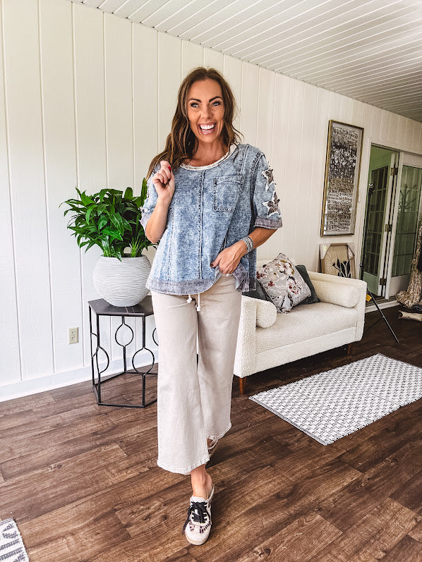 Crafted from a soft cotton-blend in a medium wash, this short-sleeved shirt features eye-catching floral and ribbed patchwork details that make it impossible to ignore. The relaxed fit, seam detailing, and front pocket keep things effortlessly comfortable, while the textured cuffs and hem add that signature boho edge.