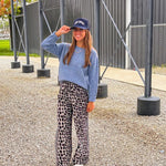 Lightweight charcoal and taupe leopard print wide leg pants with black and white stripe down the sides of the legs.