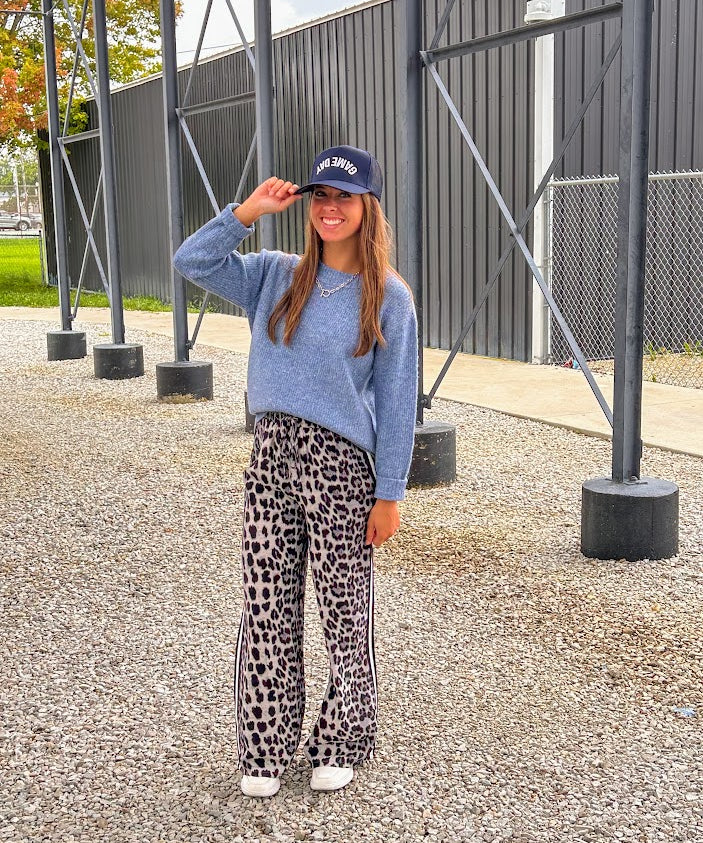 Lightweight charcoal and taupe leopard print wide leg pants with black and white stripe down the sides of the legs.