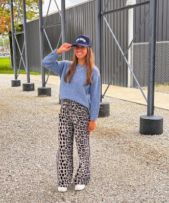 Lightweight charcoal and taupe leopard print wide leg pants with black and white stripe down the sides of the legs.