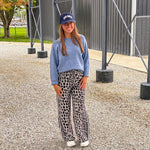 Lightweight charcoal and taupe leopard print wide leg pants with black and white stripe down the sides of the legs.