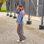 Lightweight charcoal and taupe leopard print wide leg pants with black and white stripe down the sides of the legs.