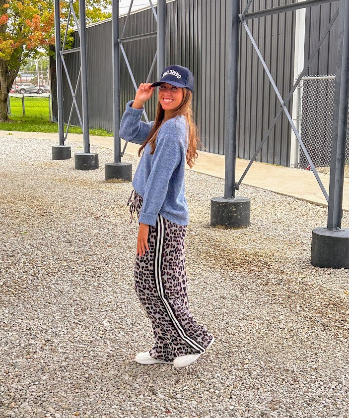 Lightweight charcoal and taupe leopard print wide leg pants with black and white stripe down the sides of the legs.