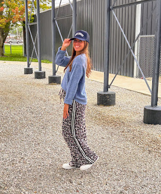 Lightweight charcoal and taupe leopard print wide leg pants with black and white stripe down the sides of the legs.
