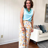 Cotton button and zipper closure bright floral pants with seams down the front of both legs and front and back pockets.