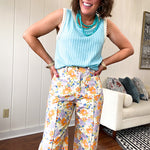 Cotton button and zipper closure bright floral pants with seams down the front of both legs and front and back pockets.