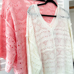 Soft, woven wide V neck sweater with 3/4 sleeves and a seashell design in the weave with exposed seams down the middle and at the shoulders. Oversized