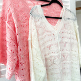 Soft, woven wide V neck sweater with 3/4 sleeves and a seashell design in the weave with exposed seams down the middle and at the shoulders. Oversized