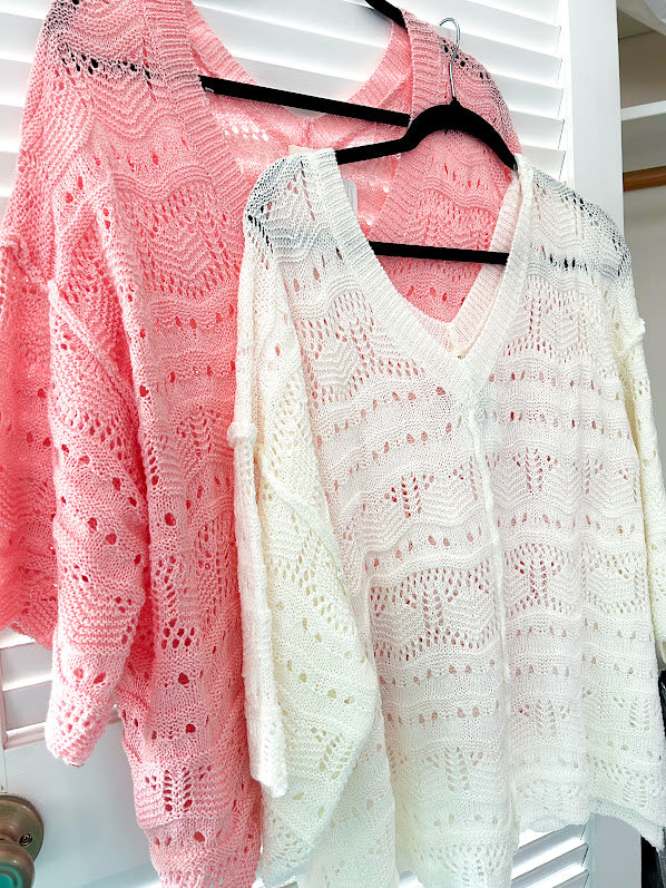 Soft, woven wide V neck sweater with 3/4 sleeves and a seashell design in the weave with exposed seams down the middle and at the shoulders. Oversized