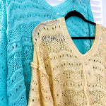 Soft, woven wide V neck sweater with 3/4 sleeves and a seashell design in the weave with exposed seams down the middle and at the shoulders. Oversized