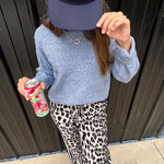 Lightweight charcoal and taupe leopard print wide leg pants with black and white stripe down the sides of the legs.