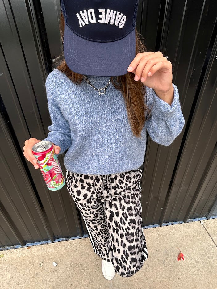 Lightweight charcoal and taupe leopard print wide leg pants with black and white stripe down the sides of the legs.