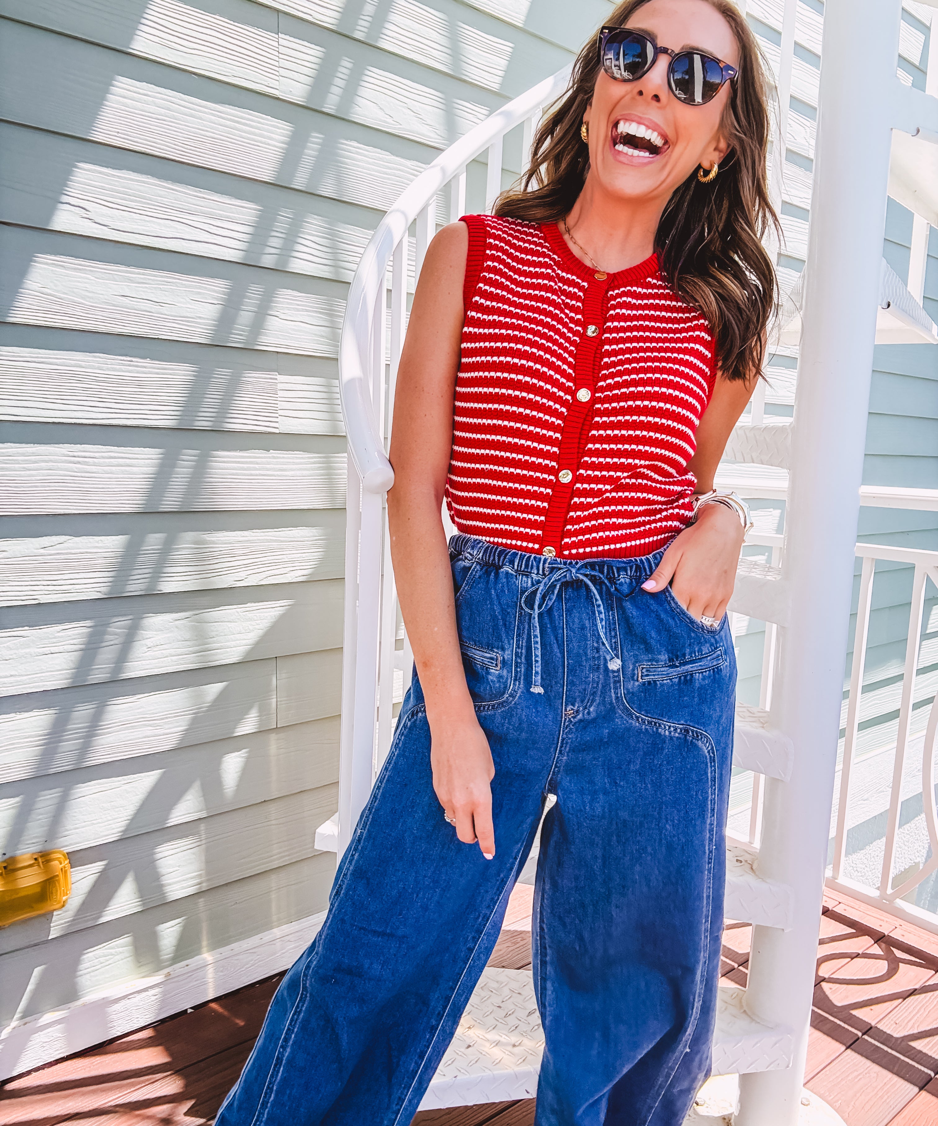 Thin red and white striped sleeveless vest with gold buttons down the front.