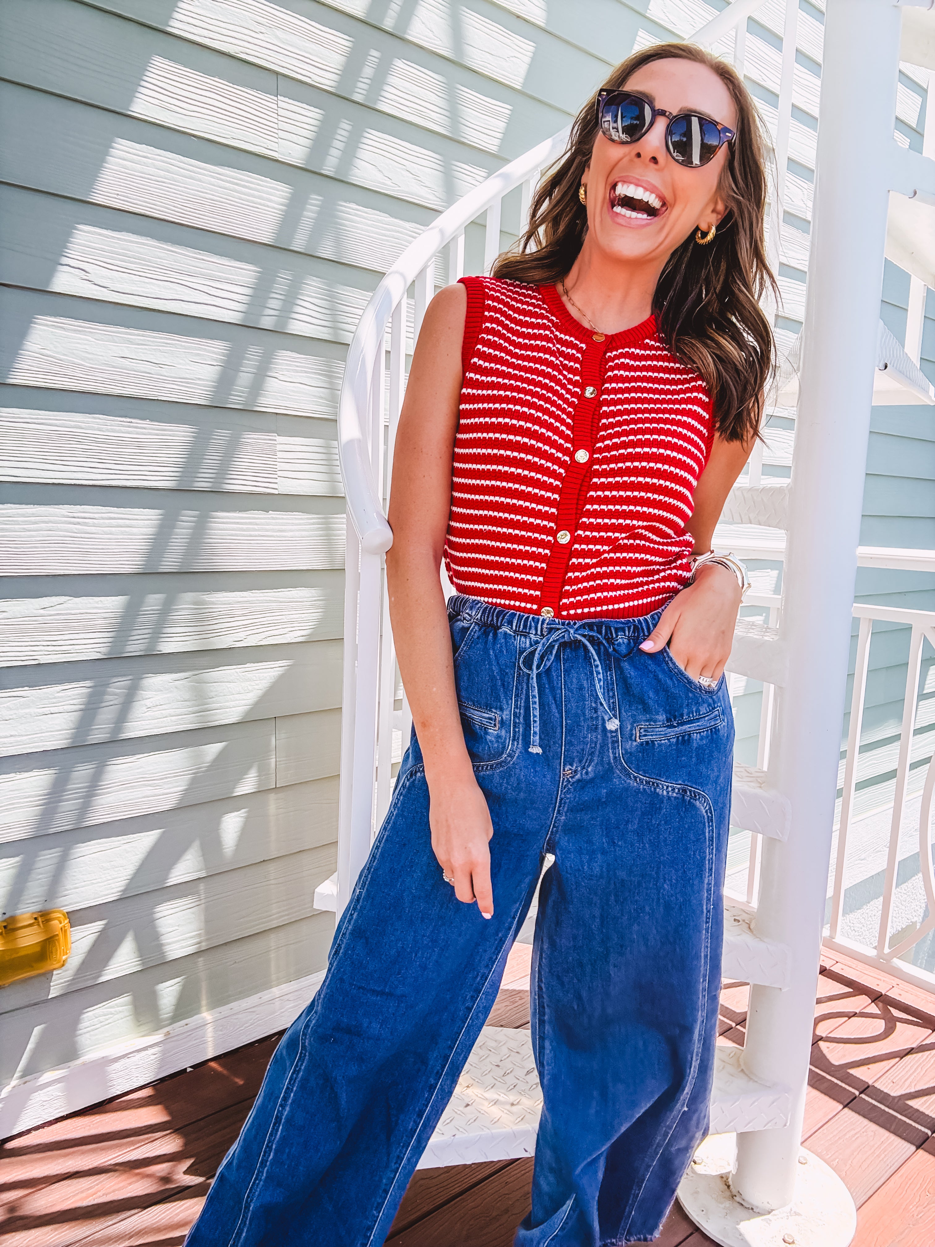 Thin red and white striped sleeveless vest with gold buttons down the front.