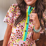 Blush and orange multi colored leopard print dress with short sleeves, 1/4 button front with yellow and teal stripes and pockets. Mini length.