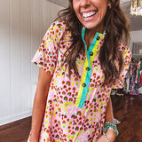 Blush and orange multi colored leopard print dress with short sleeves, 1/4 button front with yellow and teal stripes and pockets. Mini length.
