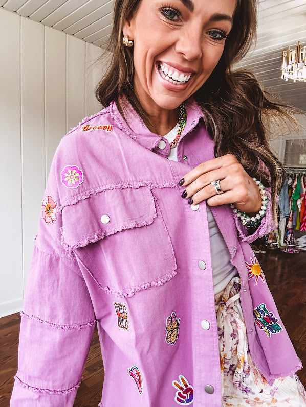 Washed orchid lightweight snap button top with exposed seams and groovy patches throughout.