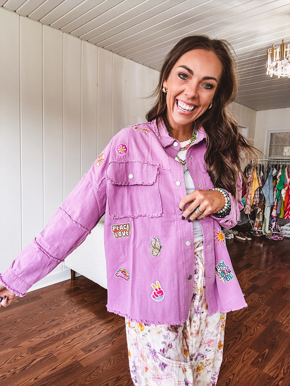 Washed orchid lightweight snap button top with exposed seams and groovy patches throughout.