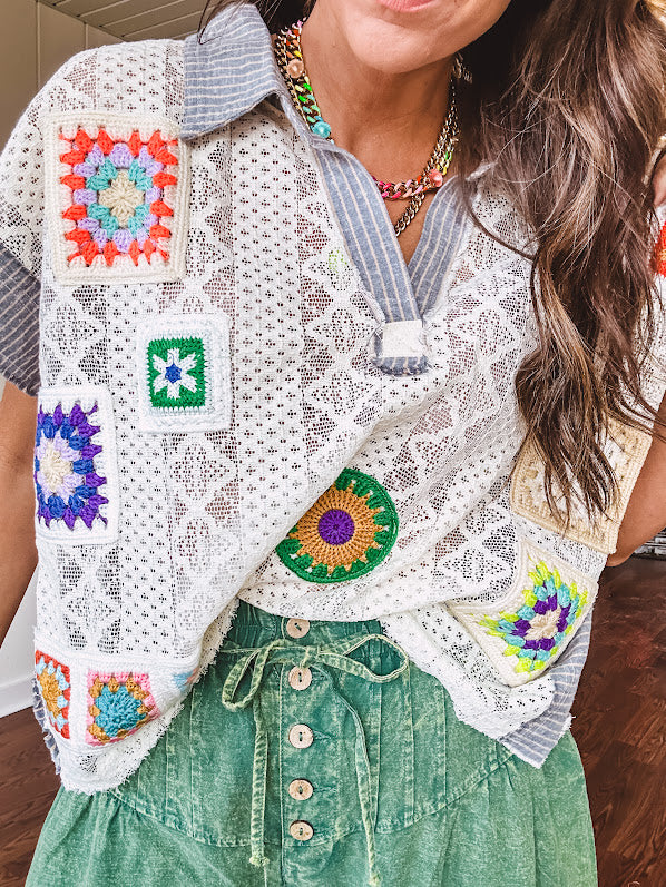 Sheer ivory crochet short sleeved top with bright crochet patches throughout, denim trim at the V neck, collar and sleeves.