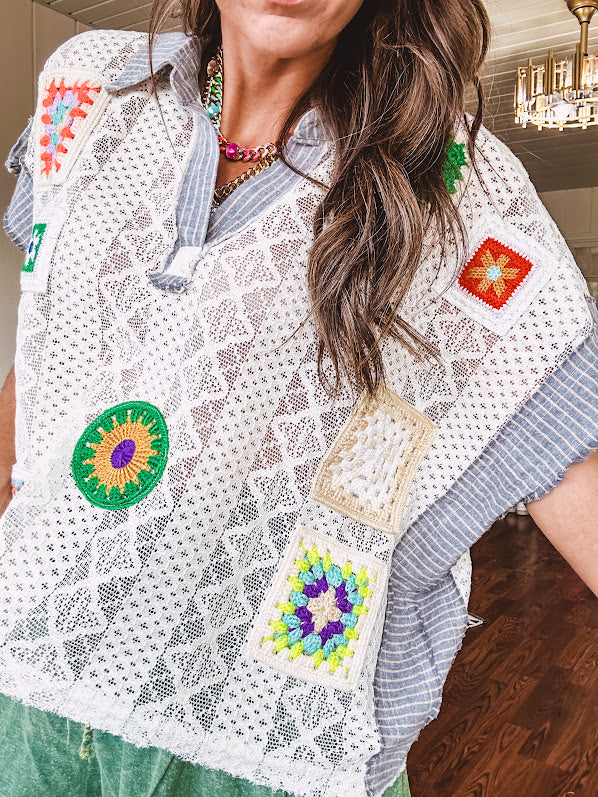 Sheer ivory crochet short sleeved top with bright crochet patches throughout, denim trim at the V neck, collar and sleeves.