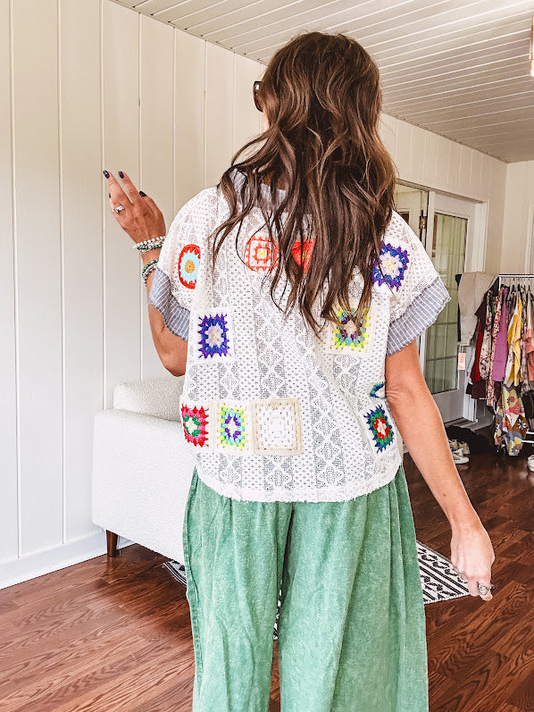 Sheer ivory crochet short sleeved top with bright crochet patches throughout, denim trim at the V neck, collar and sleeves.