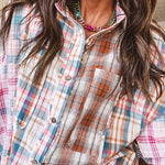 Oversized, lightweight pink, blue, cream and spice mixed plaid long sleeved top with button up front and raw hem.