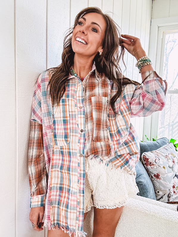 Oversized, lightweight pink, blue, cream and spice mixed plaid long sleeved top with button up front and raw hem.
