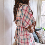 Oversized, lightweight pink, blue, cream and spice mixed plaid long sleeved top with button up front and raw hem.