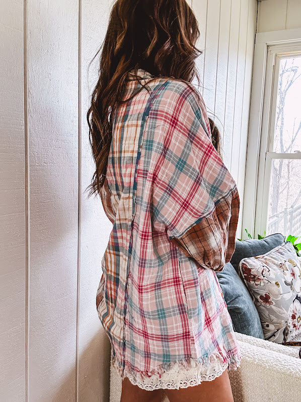 Oversized, lightweight pink, blue, cream and spice mixed plaid long sleeved top with button up front and raw hem.