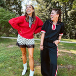 Satin shorts in cream with black polka dots and black lace at the hems with elastic waist.