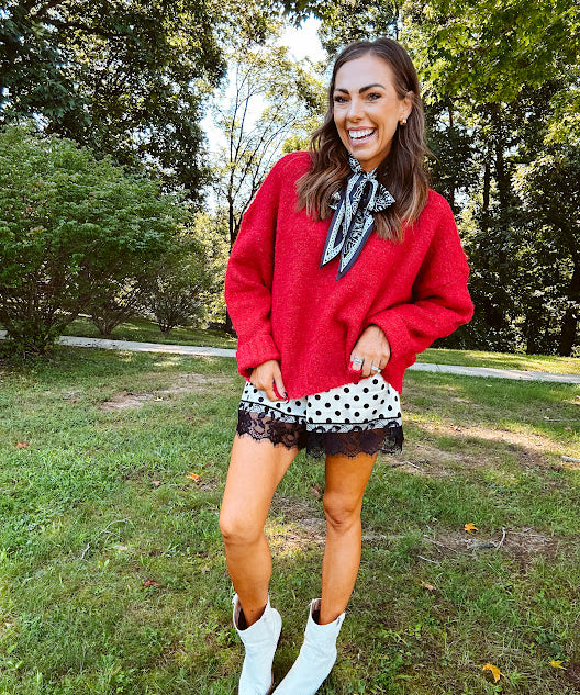 Satin shorts in cream with black polka dots and black lace at the hems with elastic waist.