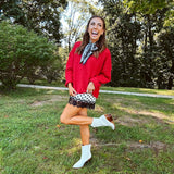Satin shorts in cream with black polka dots and black lace at the hems with elastic waist.