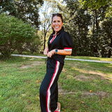 Wide leg black quilted pants with drawstring elastic waist and cream, red and taupe stripes down the legs.