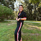Wide leg black quilted pants with drawstring elastic waist and cream, red and taupe stripes down the legs.