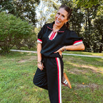 Wide leg black quilted pants with drawstring elastic waist and cream, red and taupe stripes down the legs.